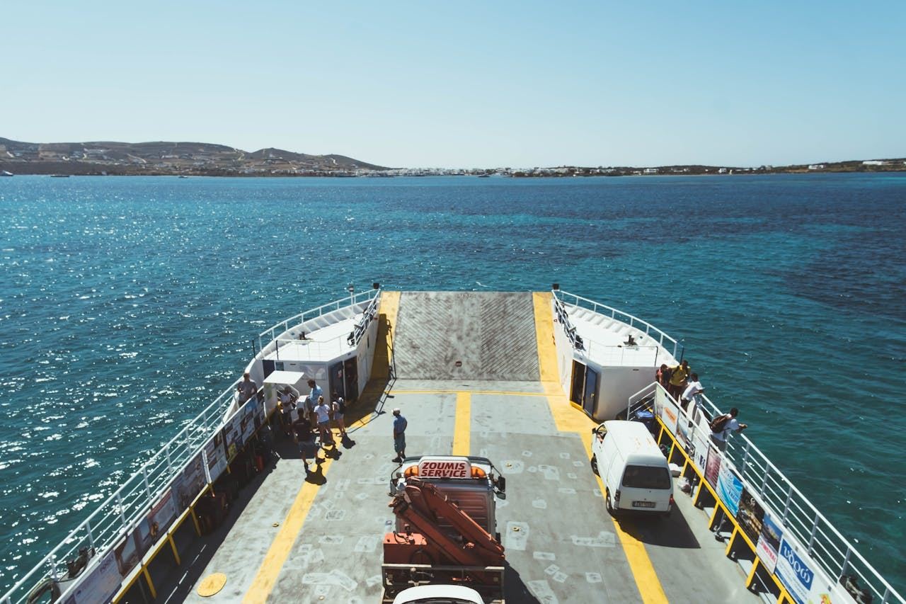 creative-03 View from a ferry deck with passengers enjoying the ocean view and distant coastline.