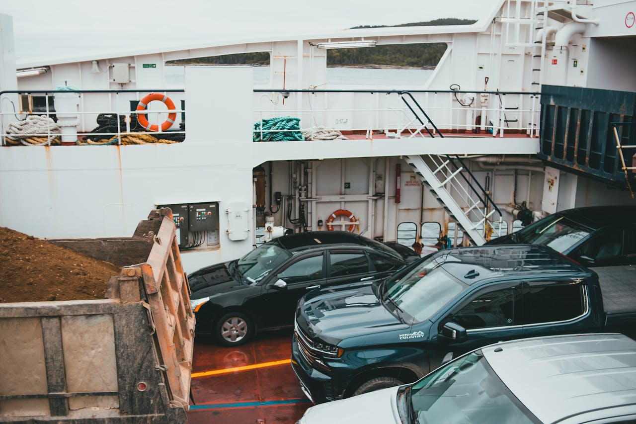 creative-02 A view of vehicles parked on a ferry deck, showcasing transportation by sea.
